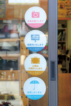 左：金沢中心商店街 武蔵活性化協議会が配布するシール。貸し傘を含む６つのサービスの目印となる